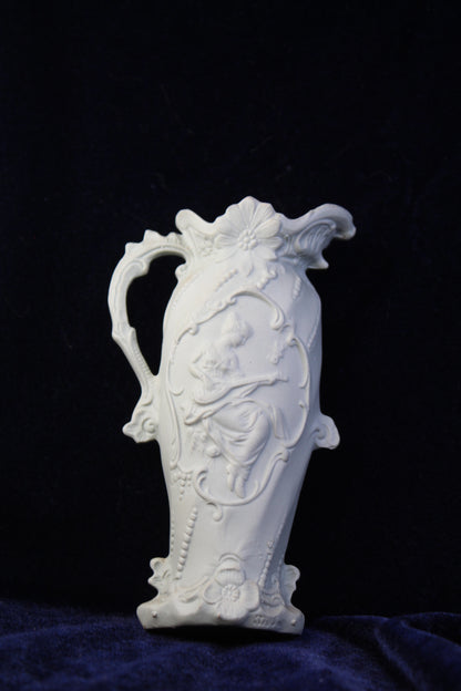 White jasperware-style vase with embossed relief of a woman playing a lute.