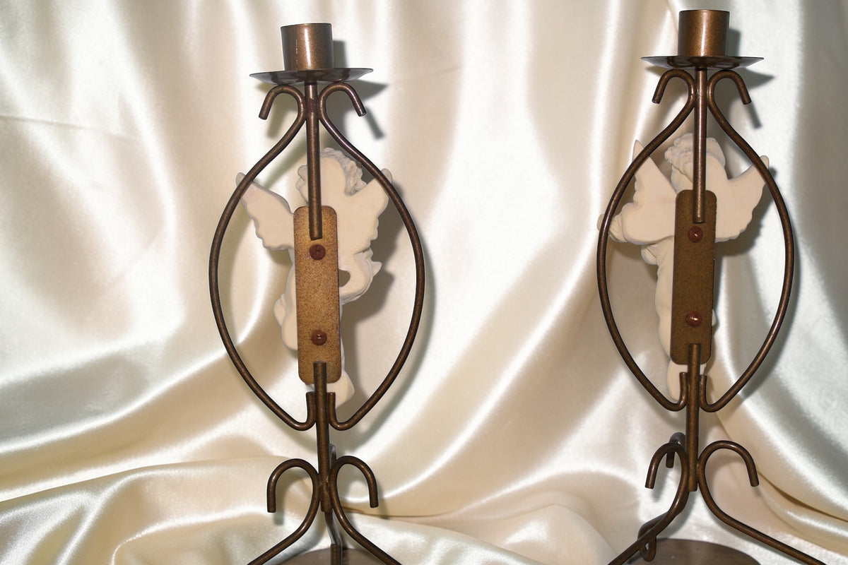 Set of 2 vintage brass candle holders with cherub figurines.