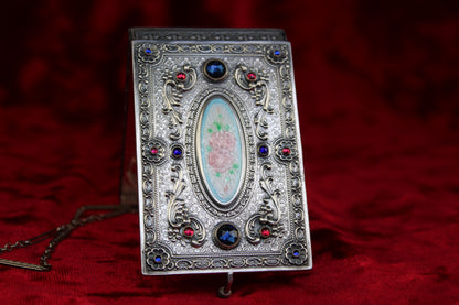 Antique French sterling silver compact with guilloché enamel rose and jewel accents.