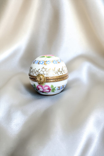 Jaestial hand-painted Limoges porcelain trinket egg with floral design and gold clasp.