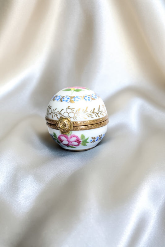 Jaestial hand-painted Limoges porcelain trinket egg with floral design and gold clasp.