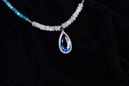 Sterling silver necklace with blue apatite, rainbow moonstone beads, and a teardrop blue gemstone pendant.