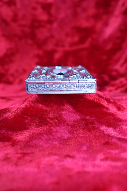 Antique French sterling silver compact with guilloché enamel rose and jewel accents.