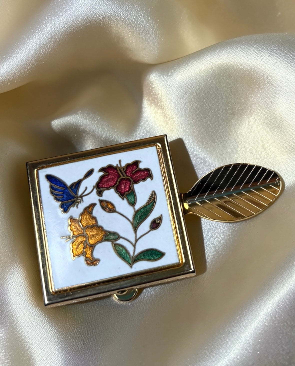 Vintage gold-tone cloisonné mini ashtray with butterfly and floral design on white enamel.