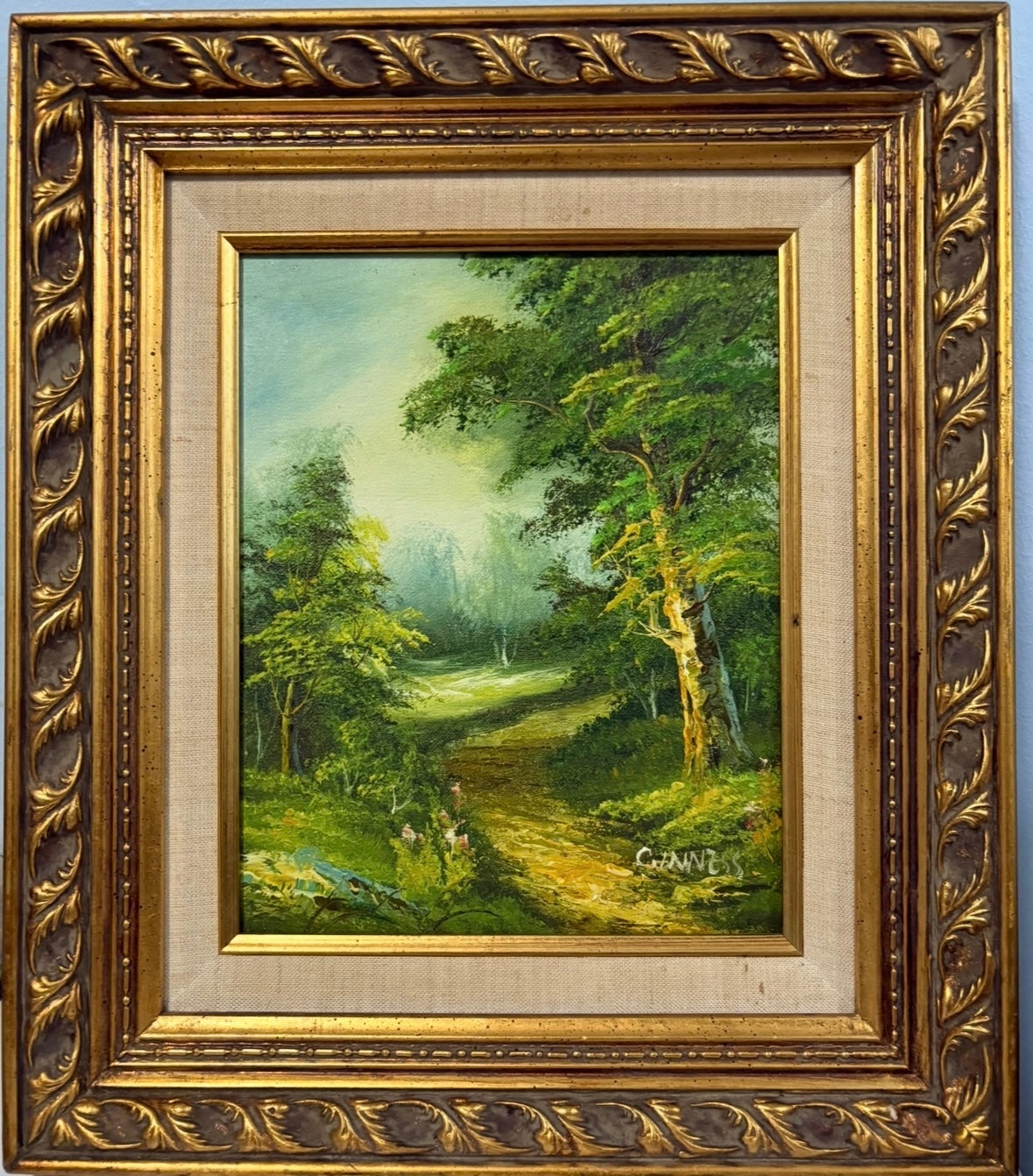Vintage forest landscape oil painting with gilded baroque frame, signed 'Gunness'.