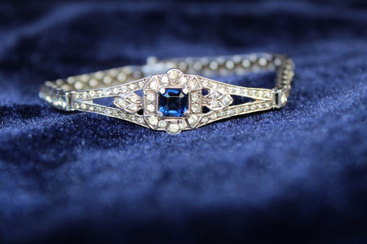 Sterling silver Art Deco bracelet with a central sapphire-blue paste stone surrounded by white paste stones.