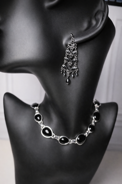 Vintage black crystal chandelier earrings and matching necklace on a black mannequin.