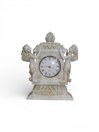 Jaestial Grand Cherub Mantel Clock with two cherubs flanking a clock face on an ornate base.