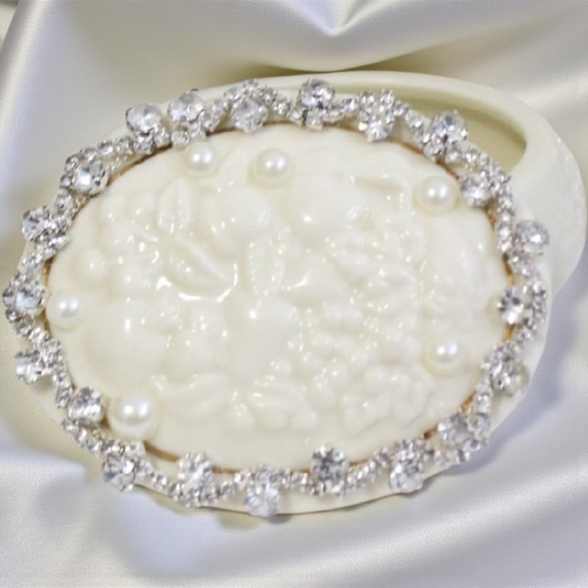 Lenox iridescent pearl trinket dish with rhinestone trim, holding small pearls.