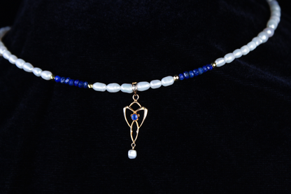 10K gold lavalier necklace with lapis lazuli beads and freshwater pearls, featuring a vintage pendant with a blue sapphire.