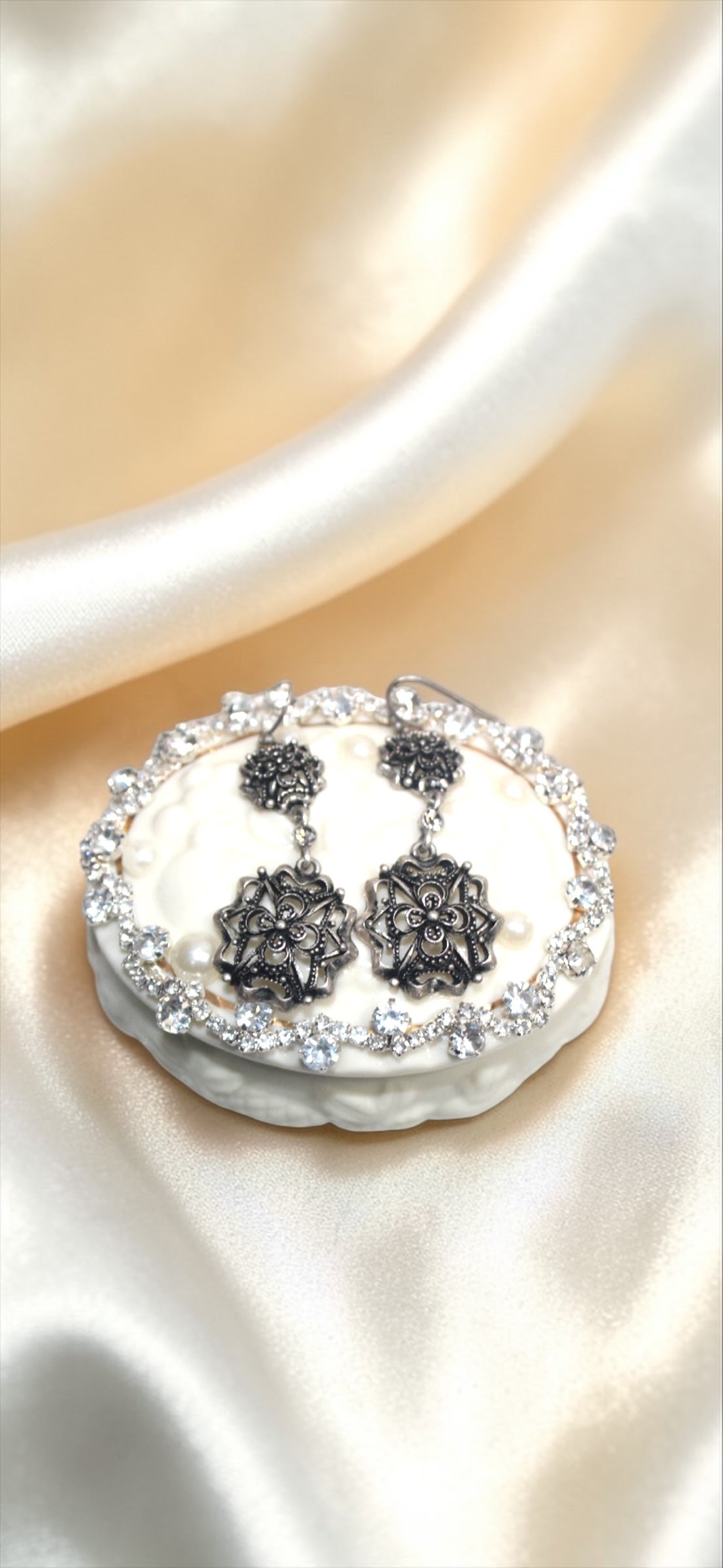 Jaestial Gothic Filigree Earrings with antique metalwork and clear stones on a white display.