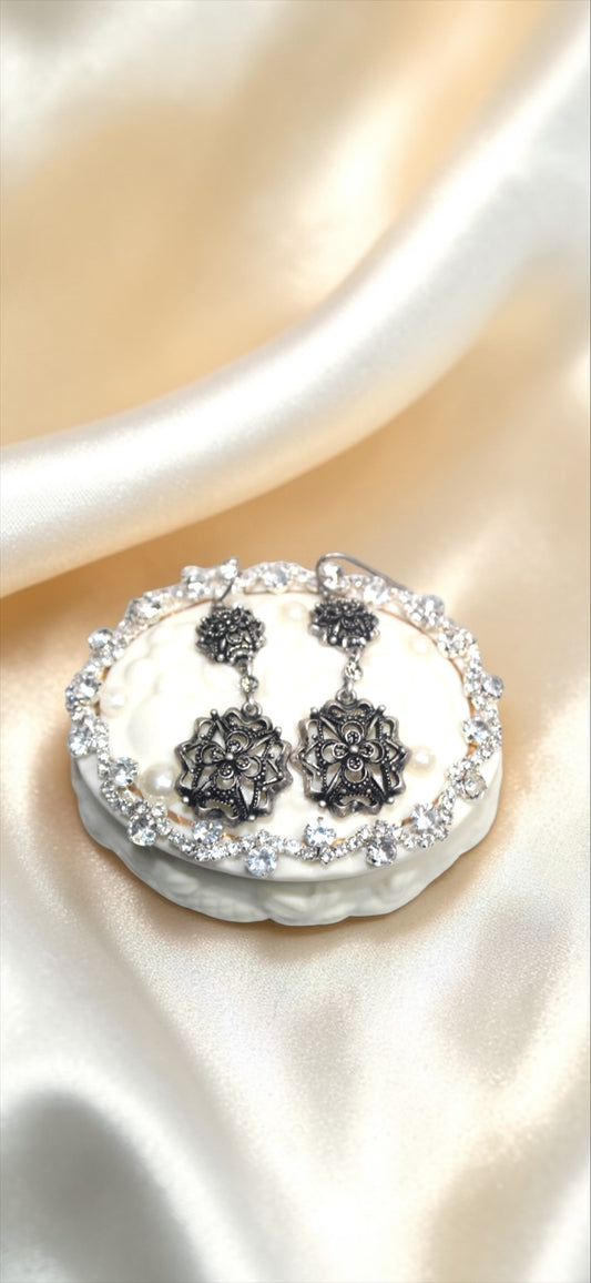 Jaestial Gothic Filigree Earrings with antique metalwork and clear stones on a white display.