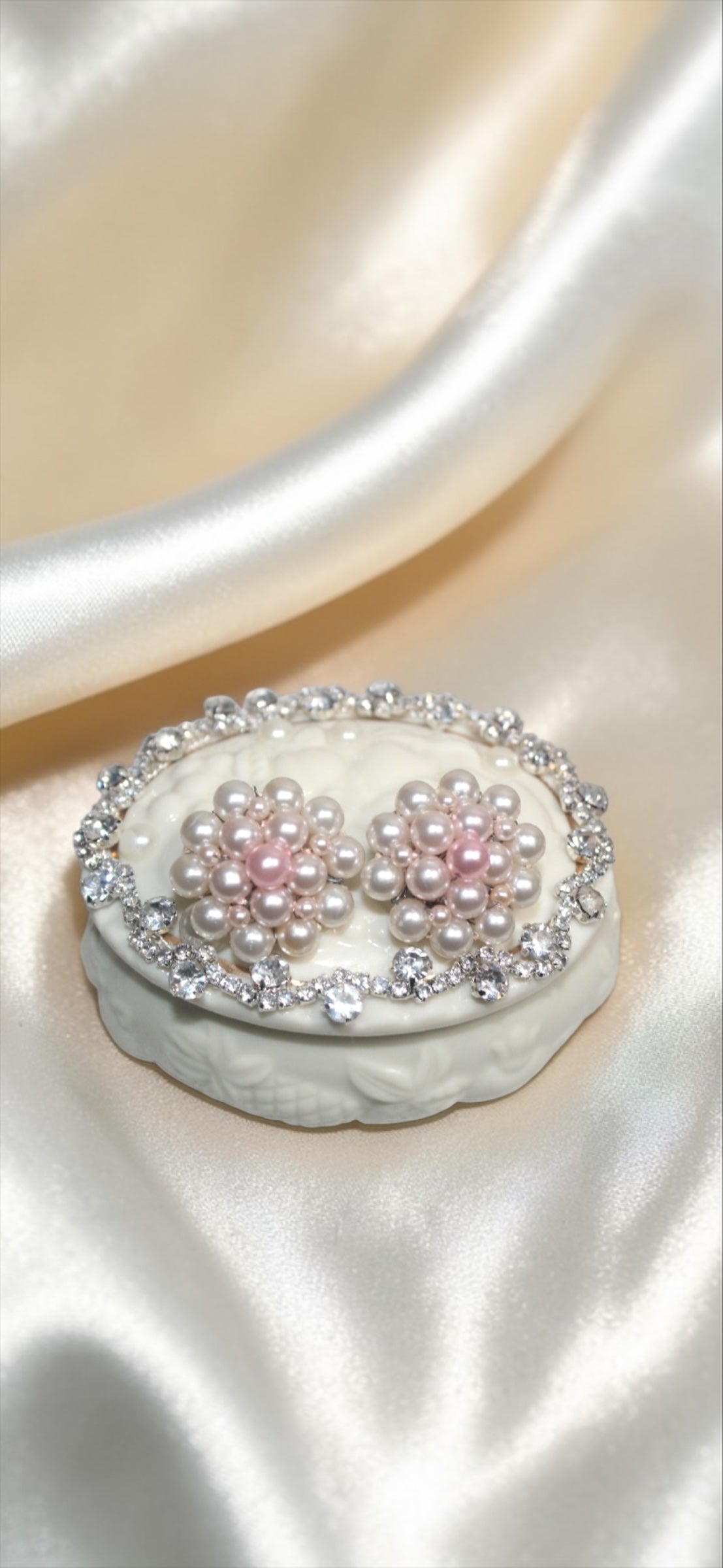 Jaestial Ballerina Blossom earrings with faux pearls and rhinestones on a decorative box.