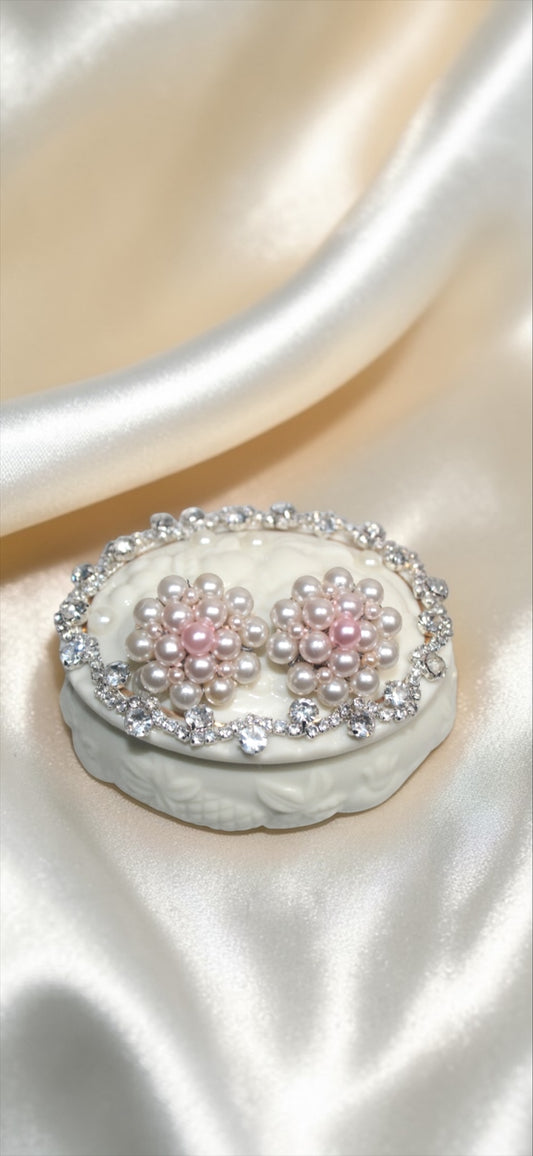 Jaestial Ballerina Blossom earrings with faux pearls and rhinestones on a decorative box.