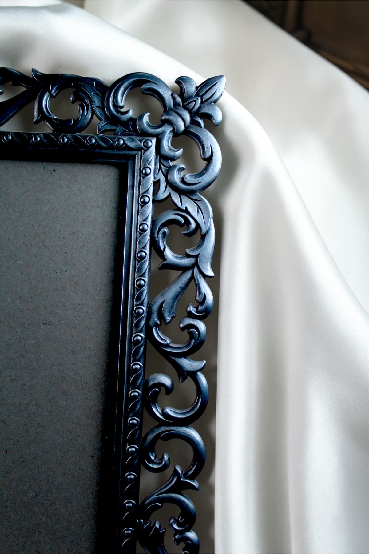 Ornate vintage metal picture frame with baroque floral detailing and an antique finish.