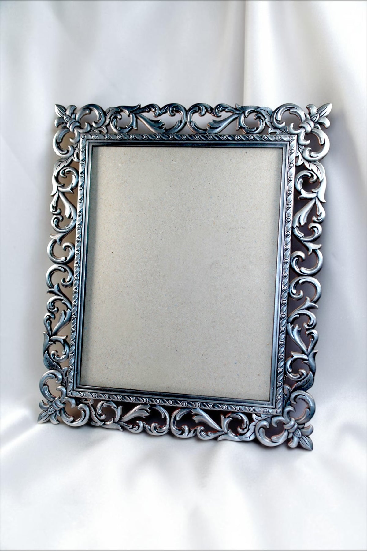 Ornate vintage metal picture frame with baroque floral detailing and antique finish.