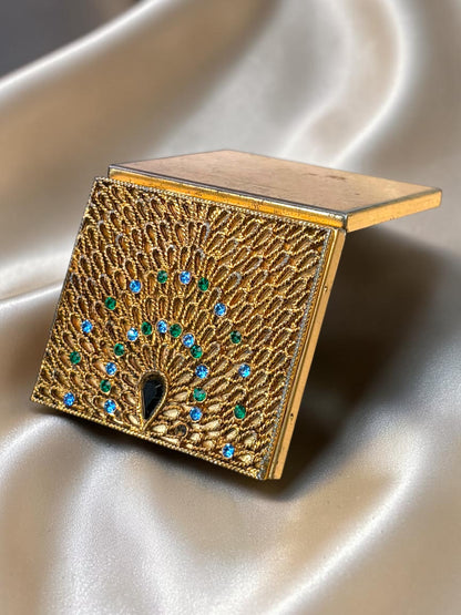 1940s ornate gold compact with peacock filigree and blue/green rhinestones.