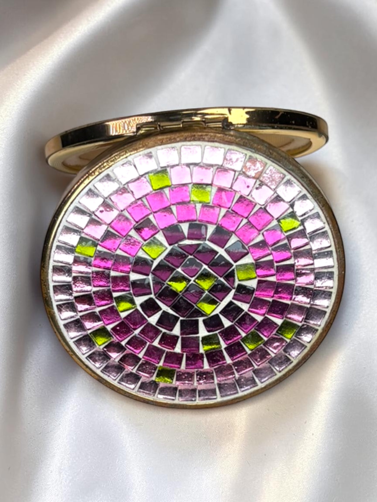 1940s Jaestial vanity compact with pink, magenta, and lime green mosaic glass tiles in a concentric pattern.